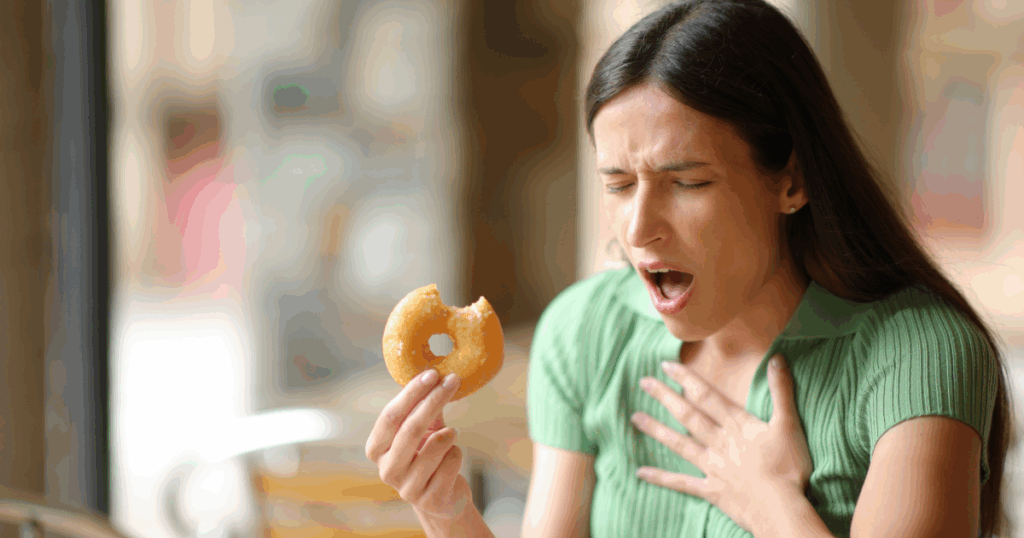 young woman choking on her treat