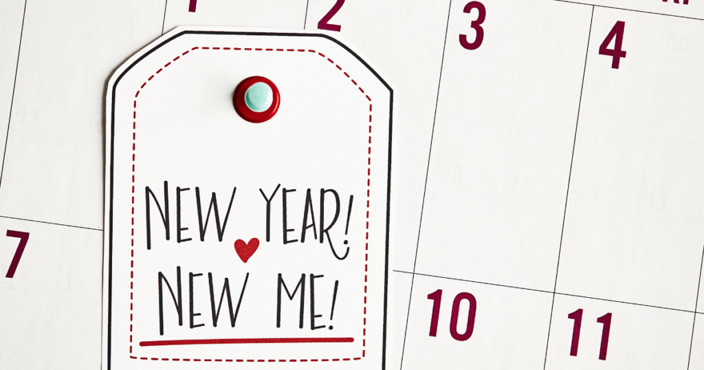 Photo of a calendar with a New Year New Me tag pinned to it