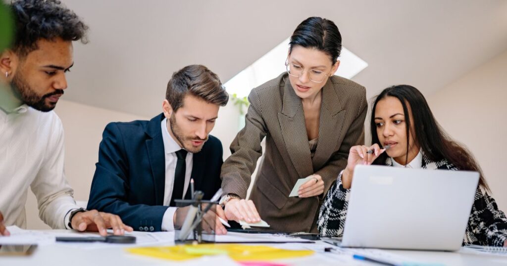 Admin learning | Pathways Career College People learning at a business conference around laptops and notebooks