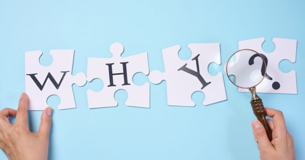 large block letters spelling WHY? on a blue background, being held by hands and a magnified glass